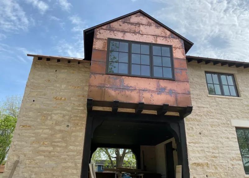 Copper metal panel facade on a stone building for Skylight Installation in Forestbrook